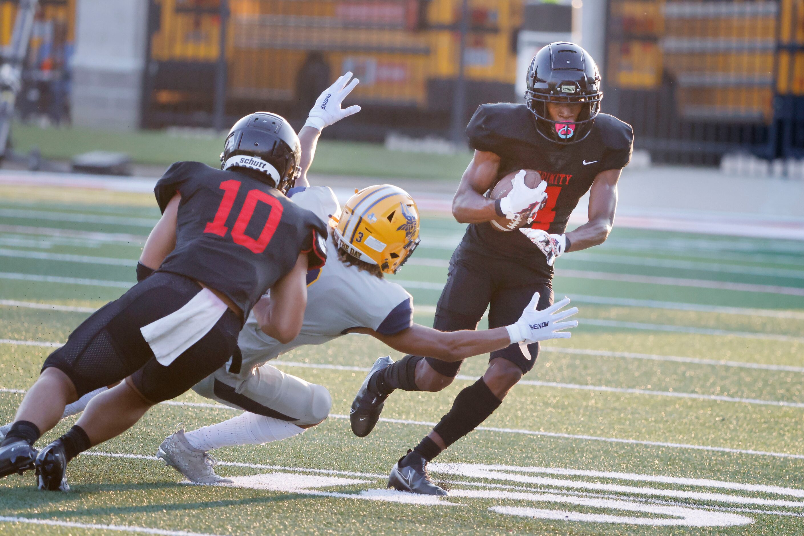 Euless Trinity defender Damarion Dean (4) returns an interception for a touchdown as...