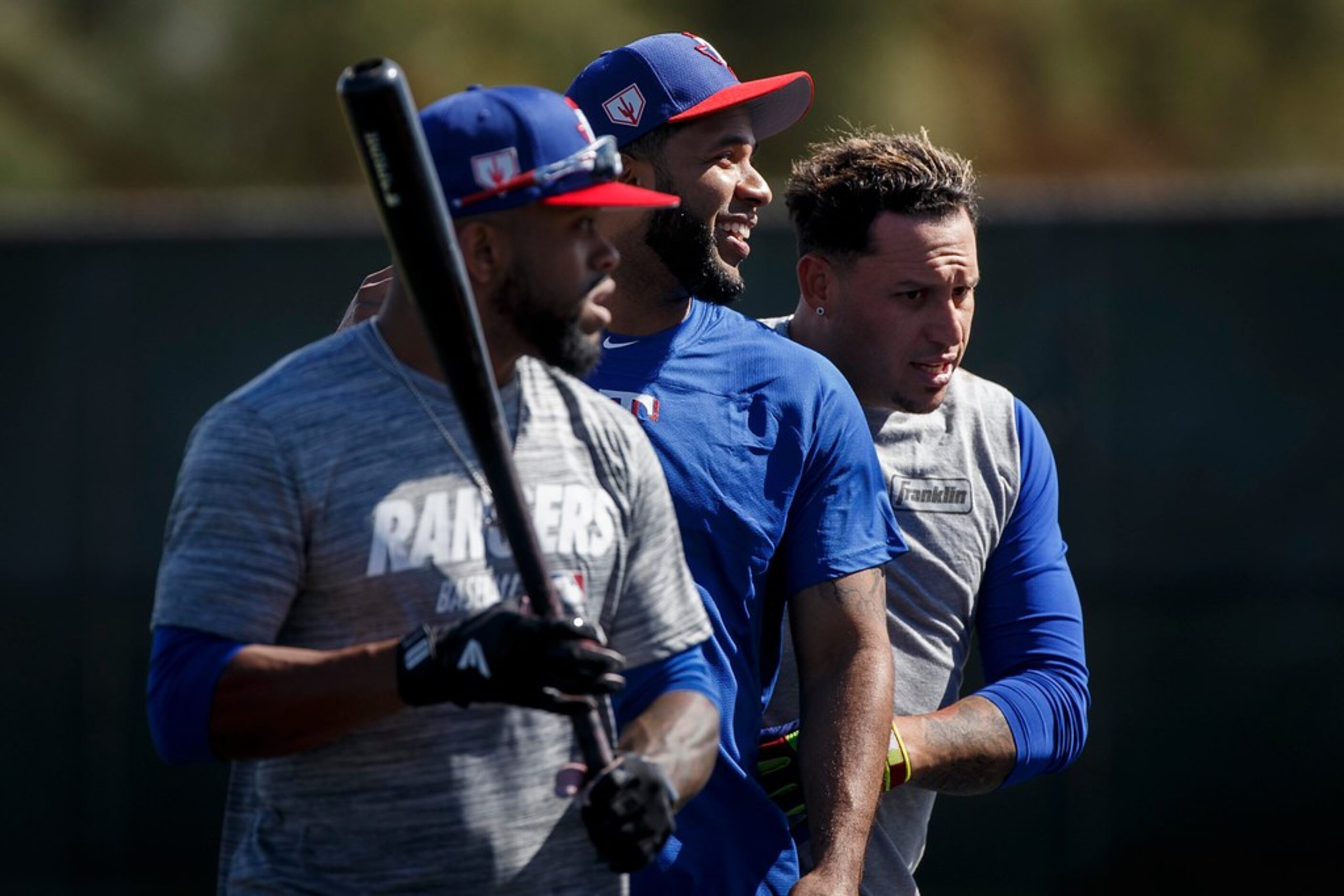 Texas Rangers shortstop Elvis Andrus (center) walks off the field with outfielder Delino...