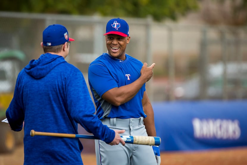 Texas Rangers third baseman Adrian Beltre talks with hitting coach Anthony Iapoce during a...