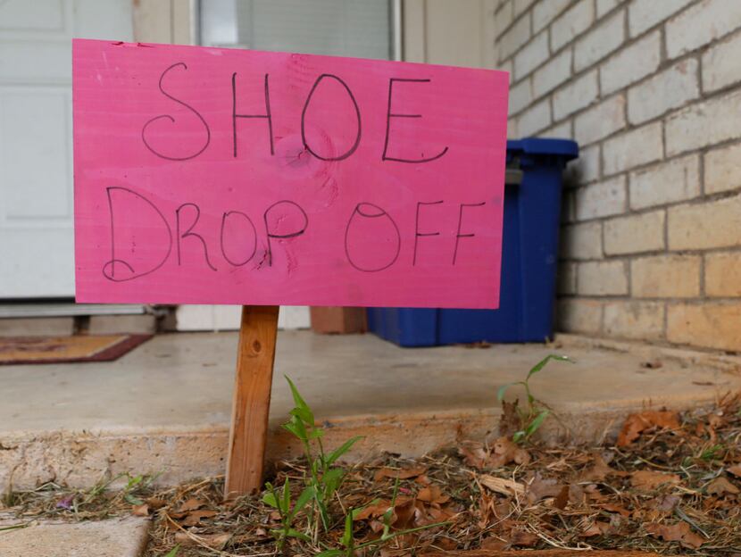 The Lasaters have a container on the front porch of their Mansfield home for donated shoes....