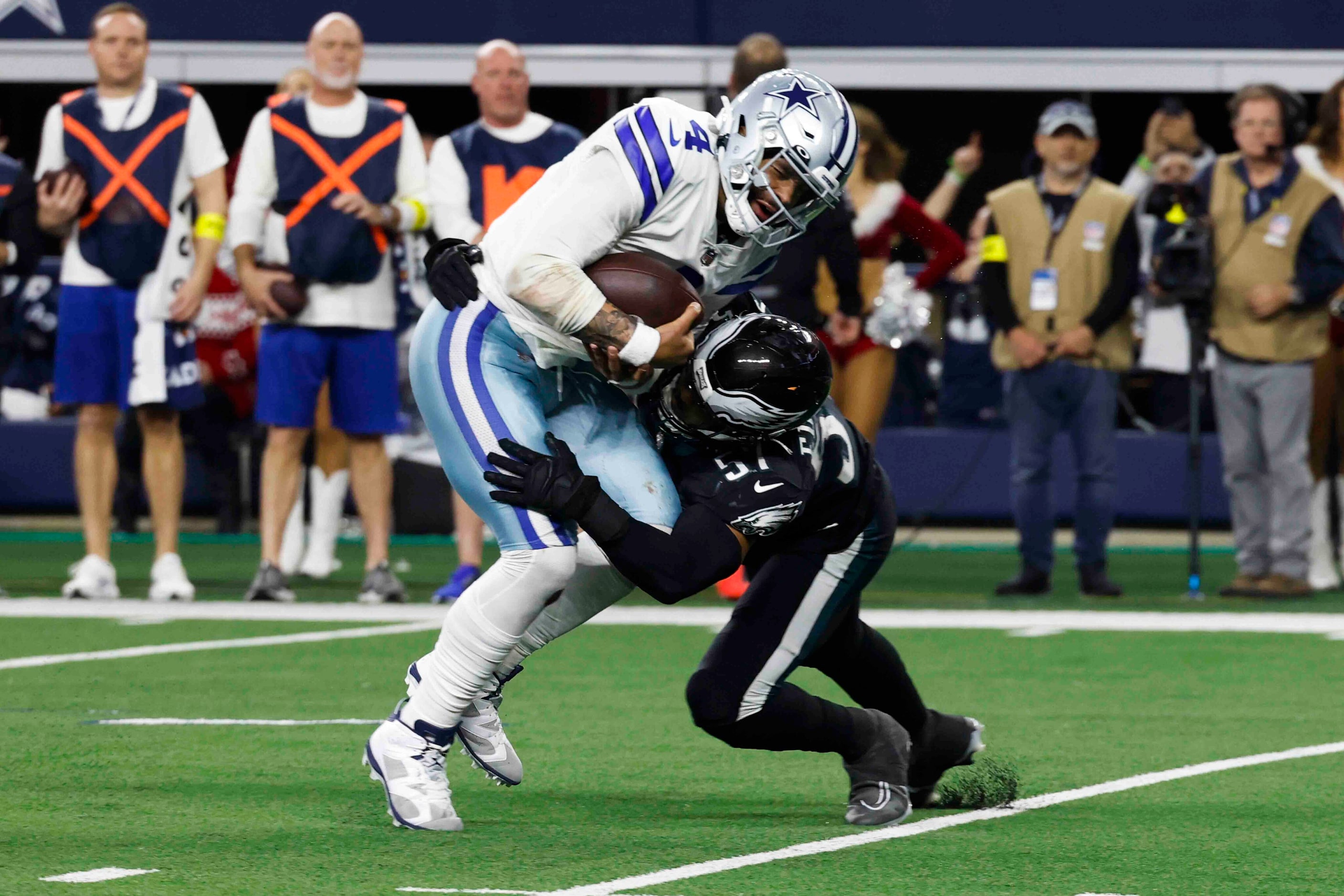 Dallas Cowboys quarterback Dak Prescott (left) is  tackled by Philadelphia Eagles linebacker...