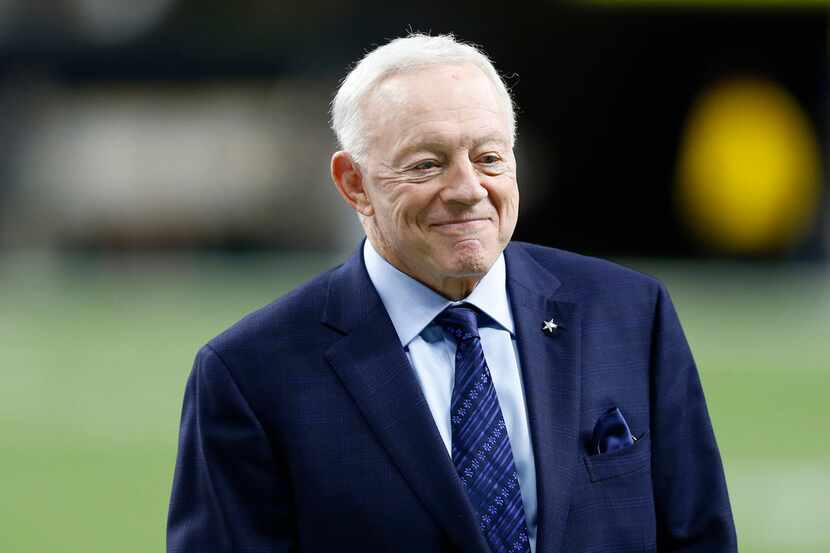 Dallas Cowboys owner and general manager Jerry Jones smiles on the field before a game...