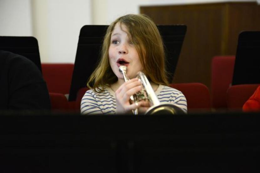 Hannah Burn, 9, reacts to music instruction during the Salvation Army Dallas Temple...