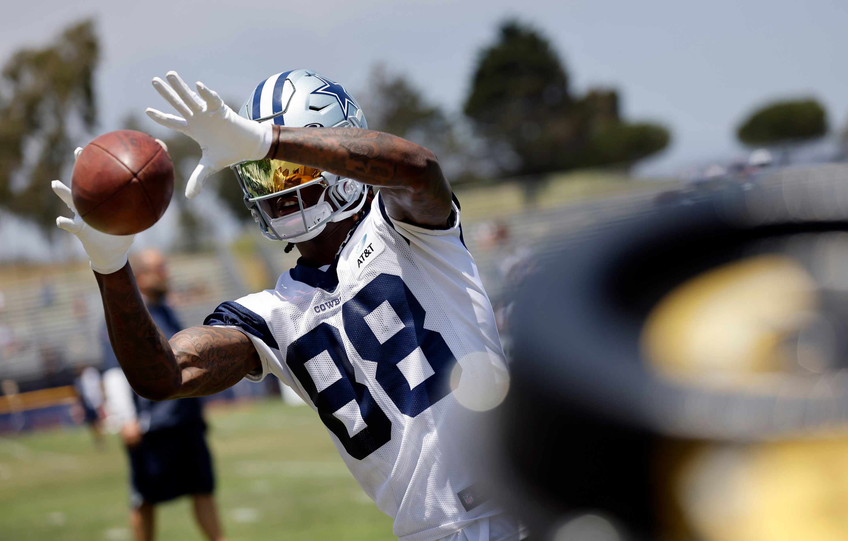 Dallas Cowboys wide receiver CeeDee Lamb (88) works on his catching skills in front of a...