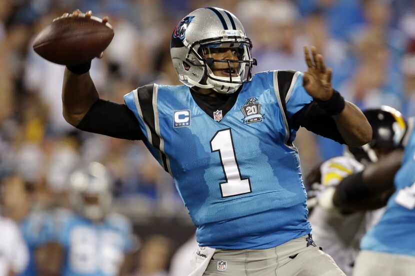 FILE - In this Sept. 21, 2014, file photo, Carolina Panthers' Cam Newton (1) looks to pass...