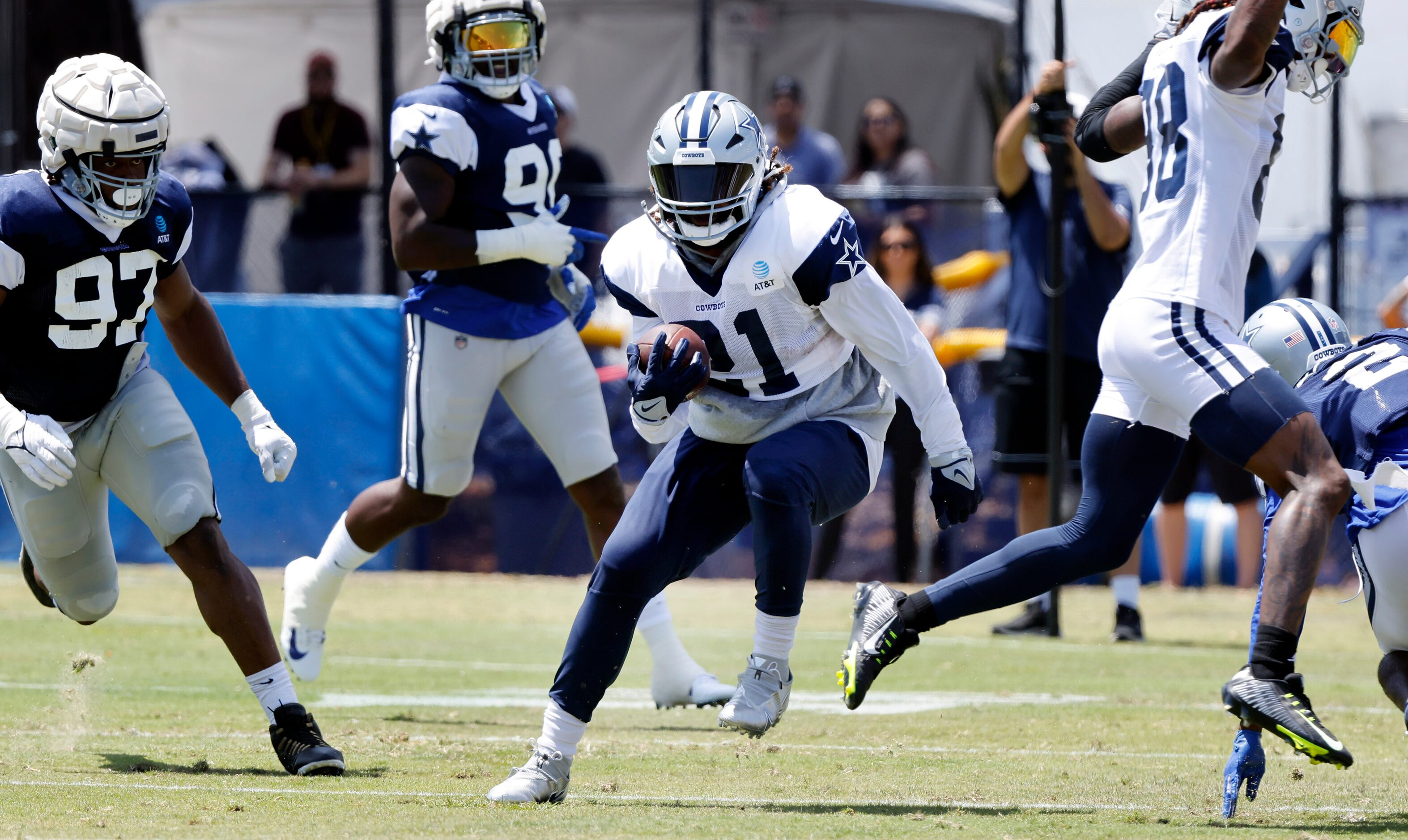 Dallas Cowboys wide receiver CeeDee Lamb (88) sidesteps Dallas Cowboys running back Ezekiel...