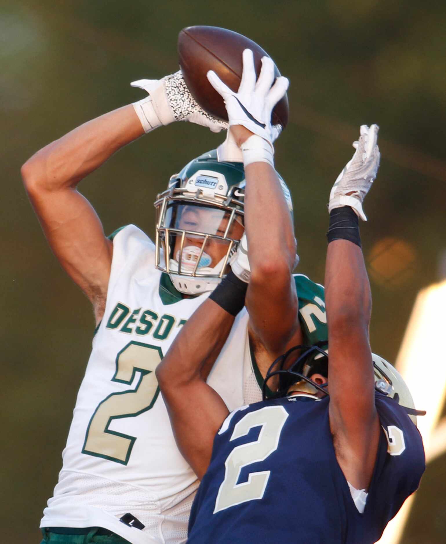 DeSoto receiver Lawrence Arnold (2) leaps high to pull in a first quarter touchdown pass...