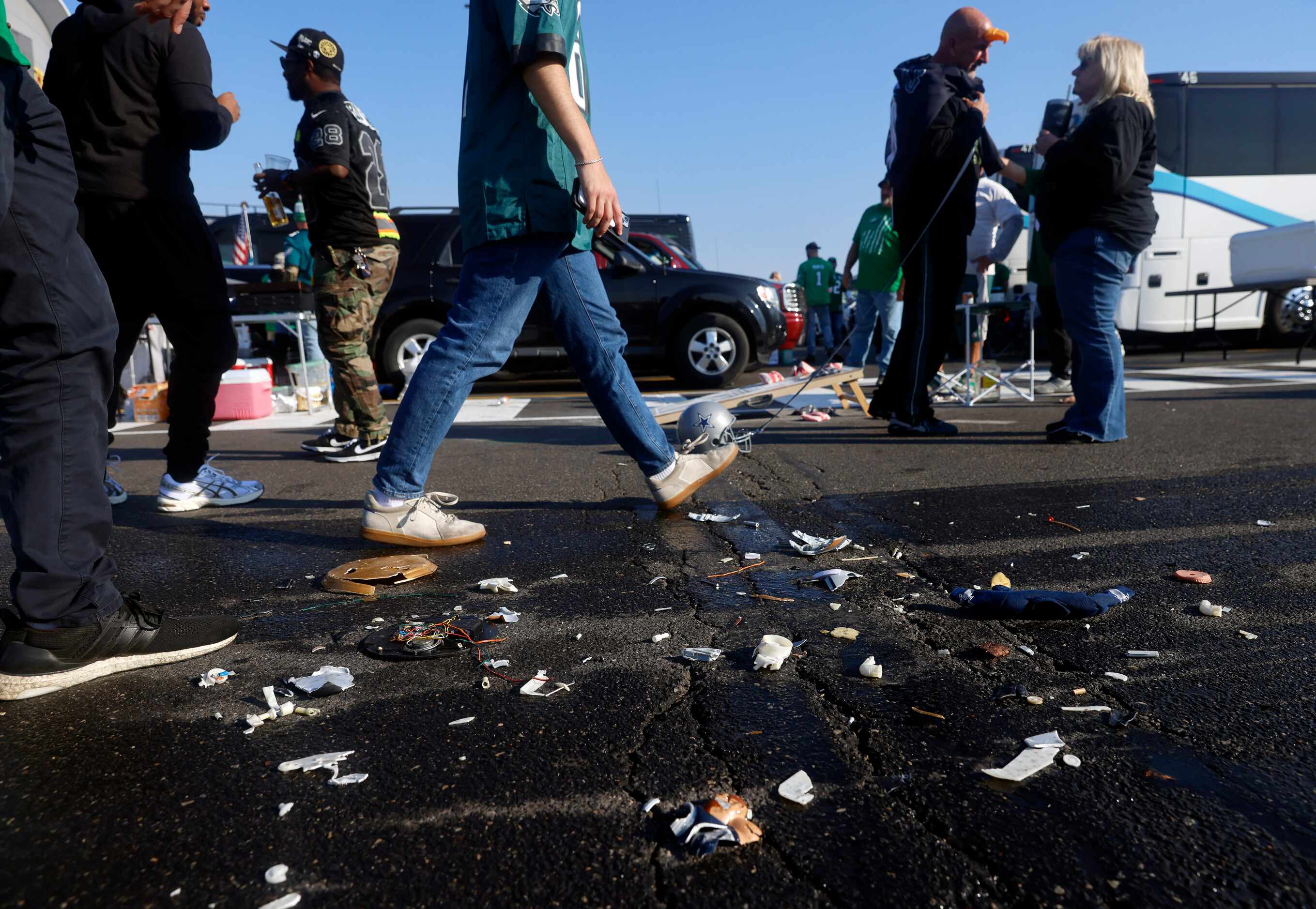 Philadelphia Eagles fans walk past a Dallas Cowboys clock that was run over by vehicles at a...