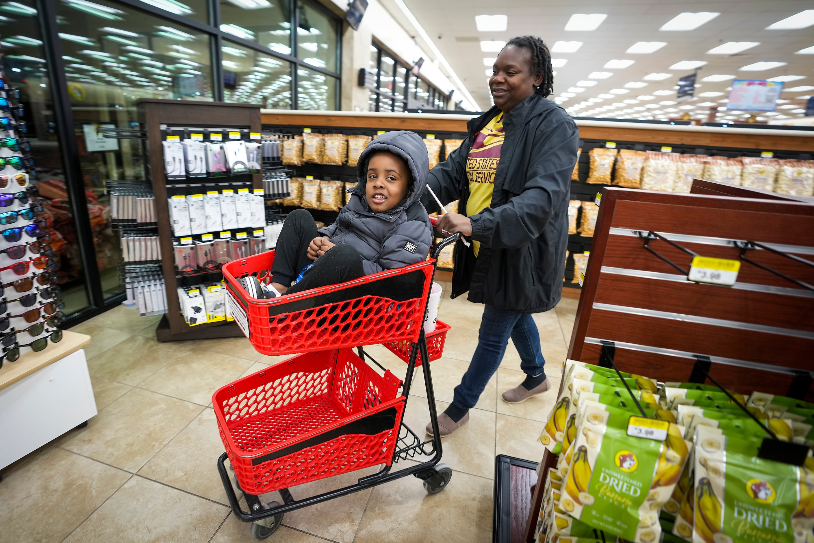 Mary Calhoun pushes her 4-year-old son Kyrie in a cart as they shop for snacks at Buc-ee's...