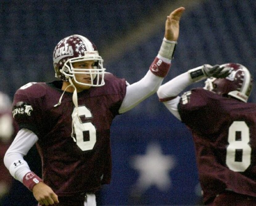 Ennis quarterback Graham Harrell celebrates with teammate Brad Cepak (81) in the second half...