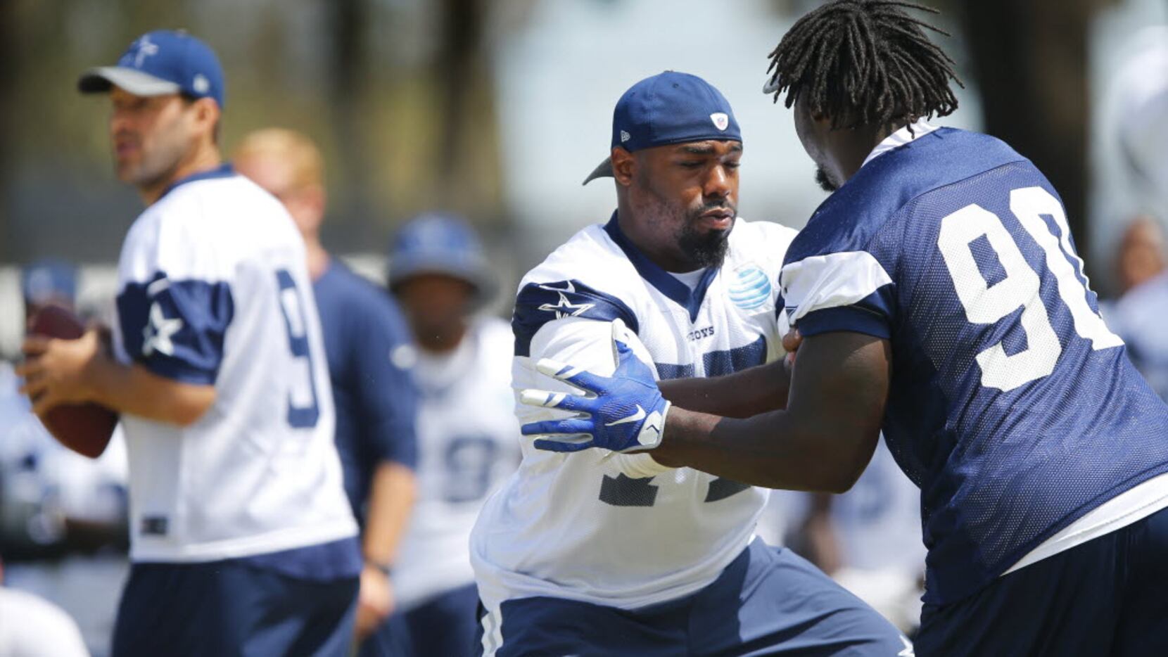 Dallas Cowboys tackle Tyron Smith (77) defends against defensive end Demarcus Lawrence (90)...