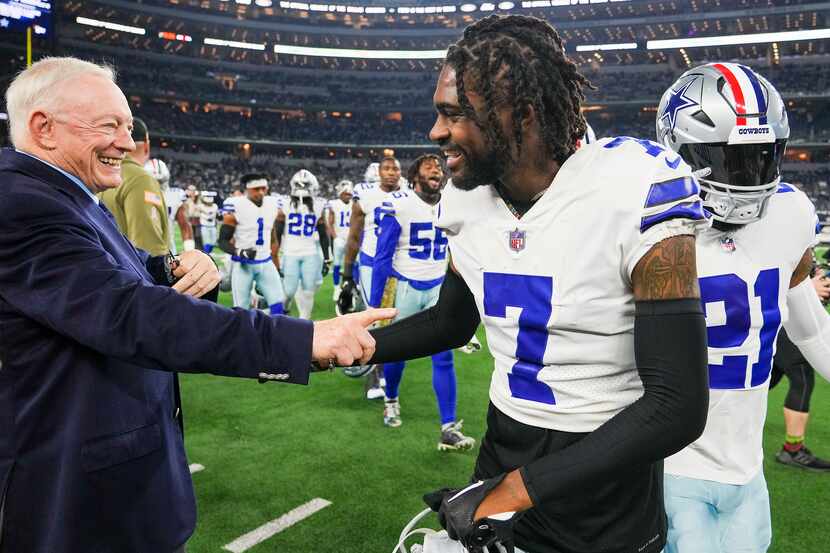 Dallas Cowboys owner and general manager Jerry Jones shakes hands with cornerback Trevon...