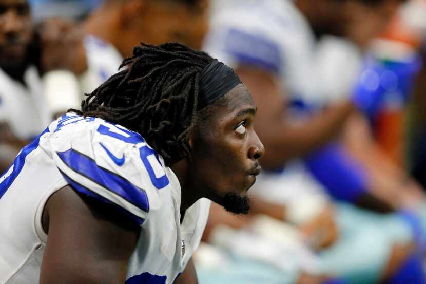 Dallas Cowboys defensive end Demarcus Lawrence (90) watches a replay from the bench in the...
