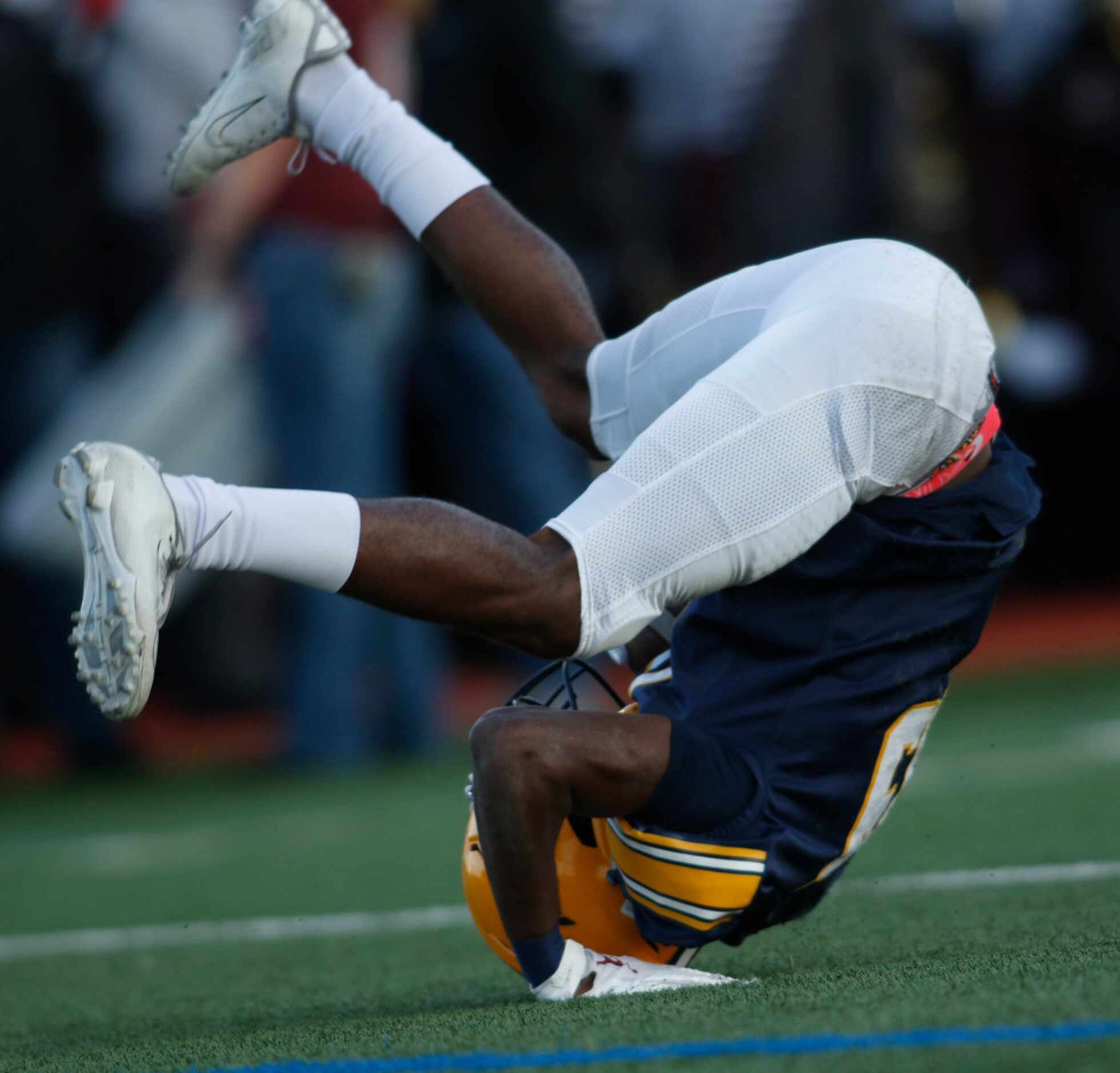 Arlington Lamar receiver Trevor West (19) turns a somersault after pulling in a 49-yard...