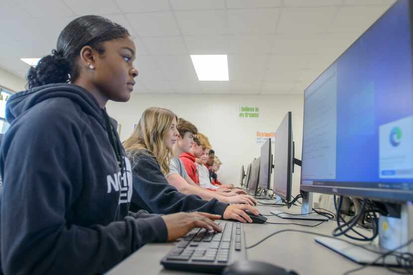 Ja'Liyah Patterson and her classmates work on an assignment in their Business Information...