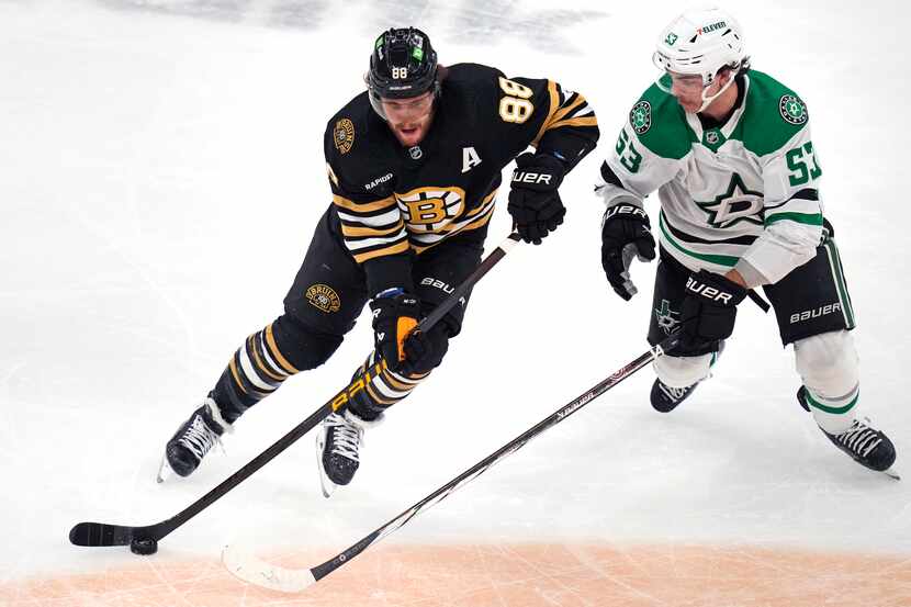 Boston Bruins forward David Pastrnak (88) skates past Dallas Stars center Wyatt Johnston...