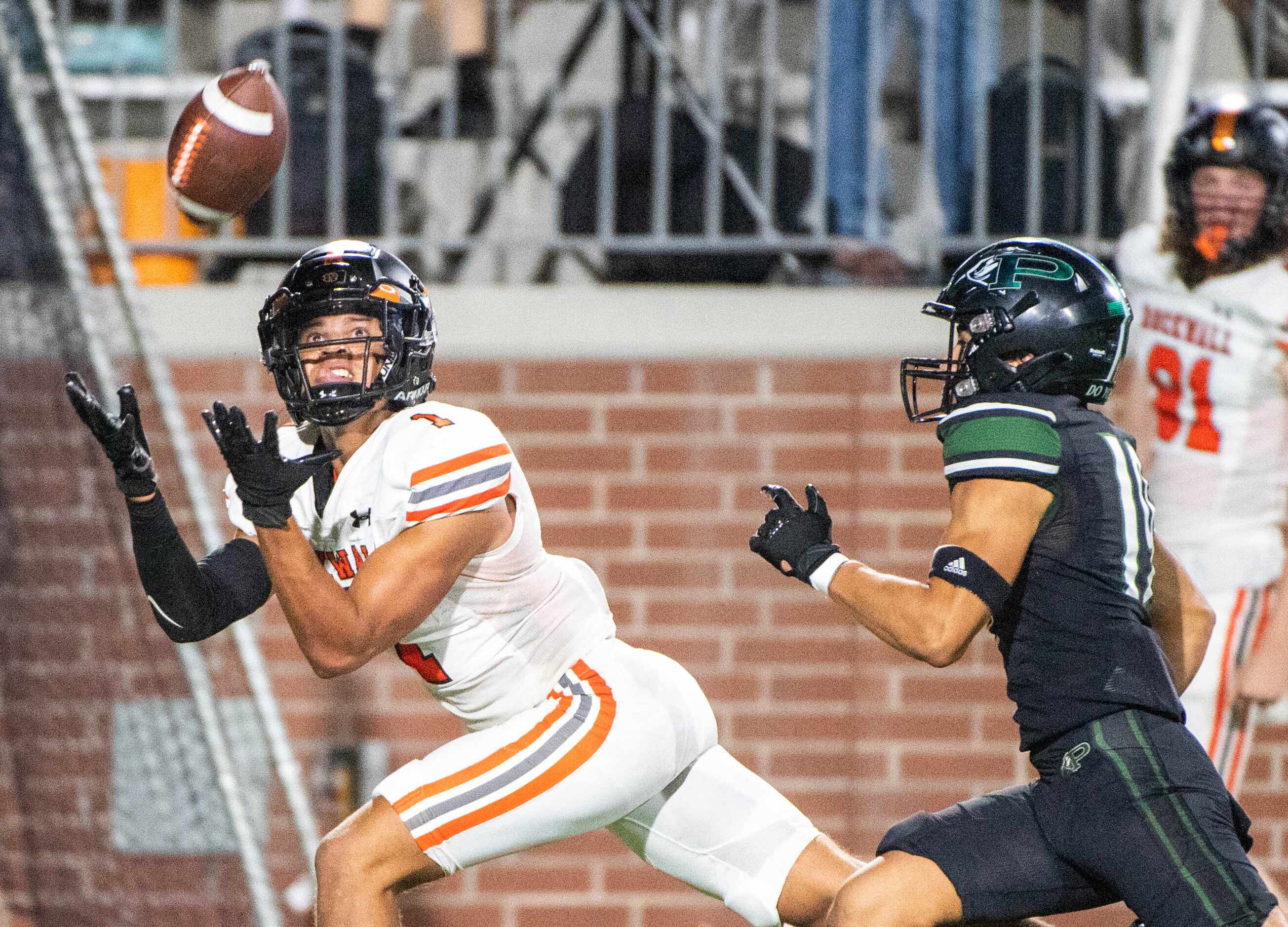 Rockwall wide receiver Aiden Meeks (1) makes a catch in front of Prosper's Bo Mongaras (19)...