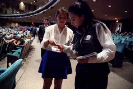  Usher Melisa Simon (right) assisted Marisa Adame at the Music Hall in Fair Park in Dallas...