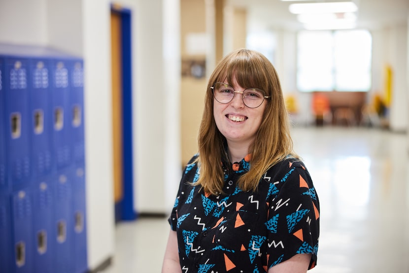 826 Dallas Program Manager Jessica Thompson pictured in large school hallway with blue...