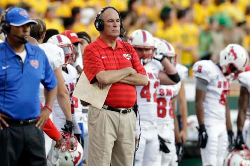 SMU head coach June Jones watches from the sidelines during the first half of an NCAA...