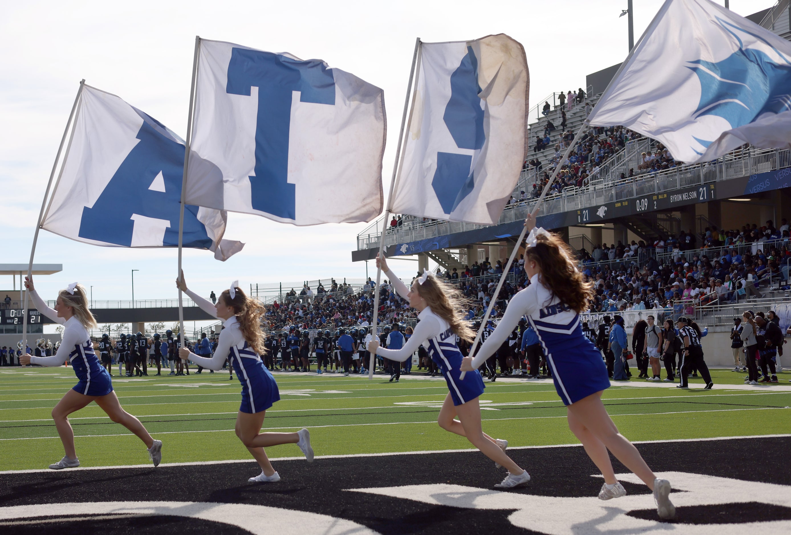 North Crowley cheerleaders race across the end zone following a first half touchdown inter...