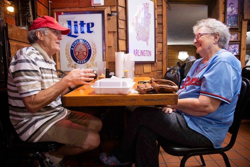 (From left) Siblings Gene Goodell and Kathy Goodell don their Texas Rangers attire as they...