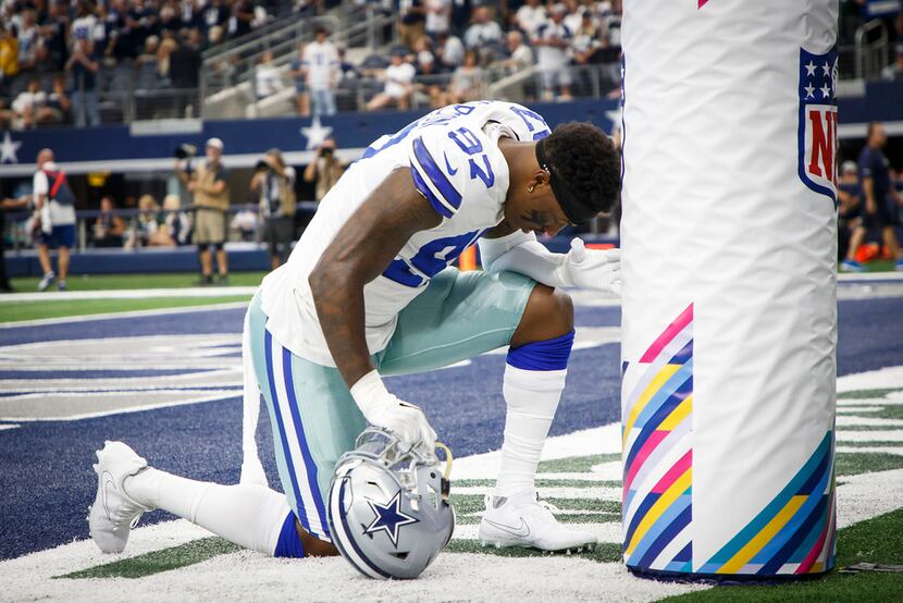 Dallas Cowboys defensive end Taco Charlton kneels in prayer before an NFL football game...