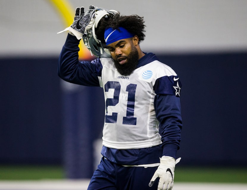 Dallas Cowboys running back Ezekiel Elliott (21) takes off his helmet during a Dallas...