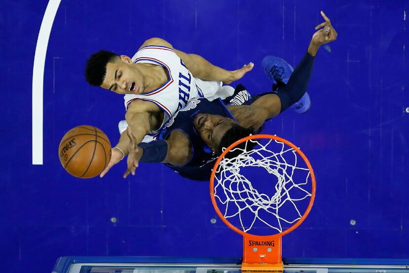 Philadelphia 76ers' Timothe Luwawu-Cabarrot top, goes up for a shot against Dallas...