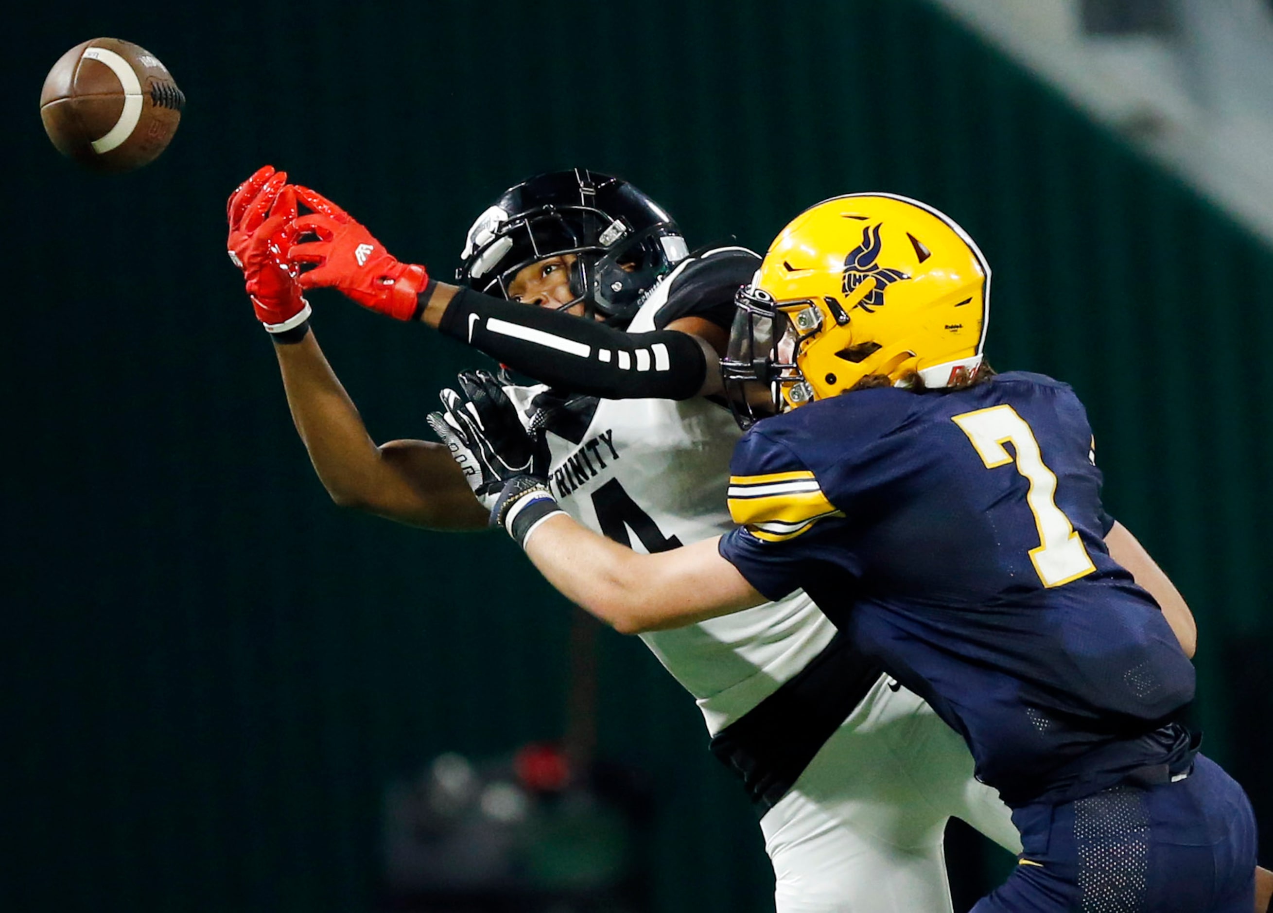 Euless Trinity wide receiver Max Bosilikwa (4) can't corral a pass as he's covered by...