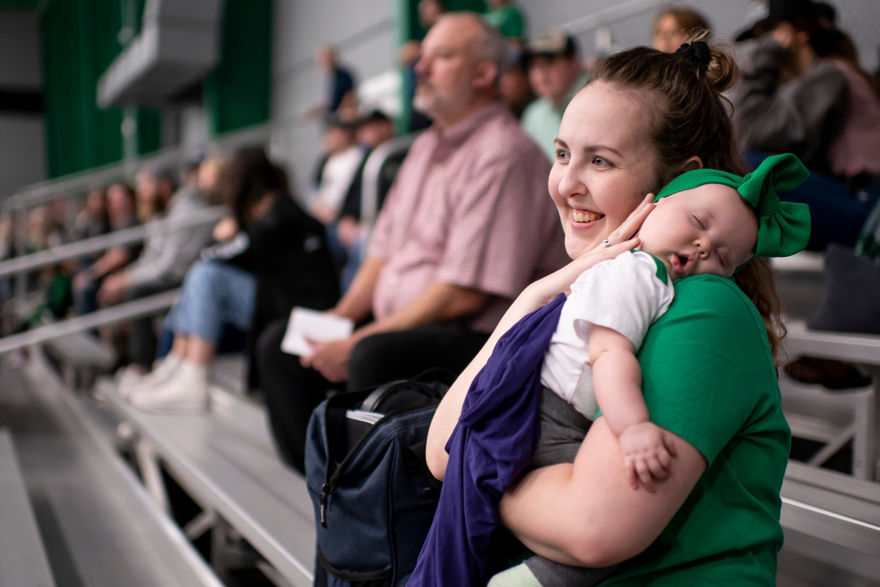 Lindy McKie holds her daughter, Charlotte, 5 months, while watching the 2022 Dallas Stars...