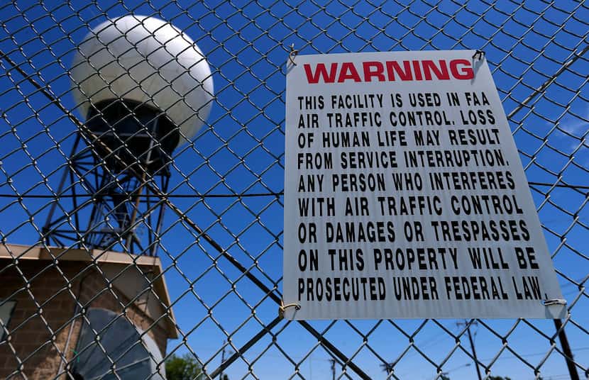 A warning sign is seen on the fence of a Doppler weather radar station near the Cypress...