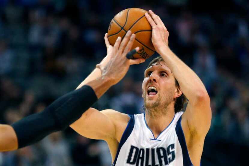 Dallas Mavericks forward Dirk Nowitzki (41) pulls up and takes a three-point shot during the...