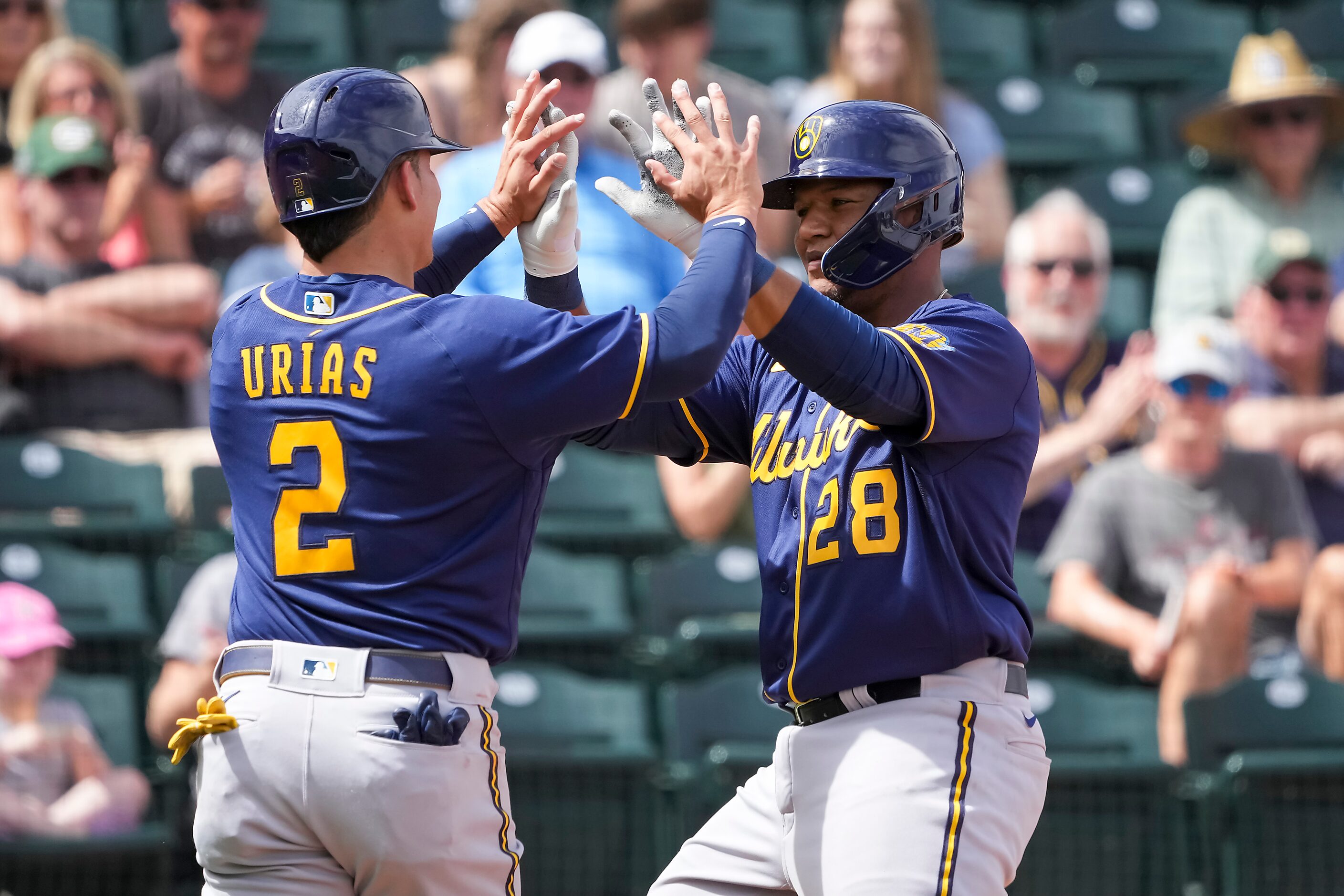 Milwaukee Brewers catcher Pedro Severino celebrates with shortstop Luis Urias after hitting...