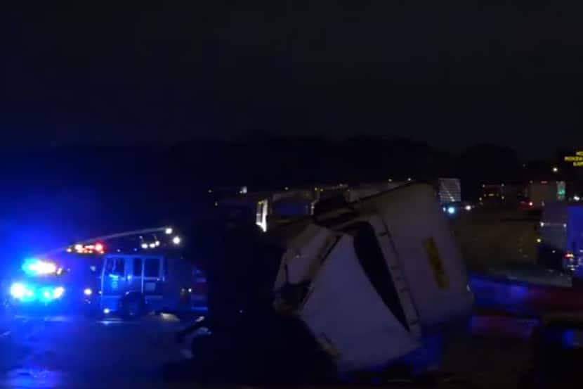 An 18-wheeler lies on its side after it was involved in a wreck with another vehicle that...
