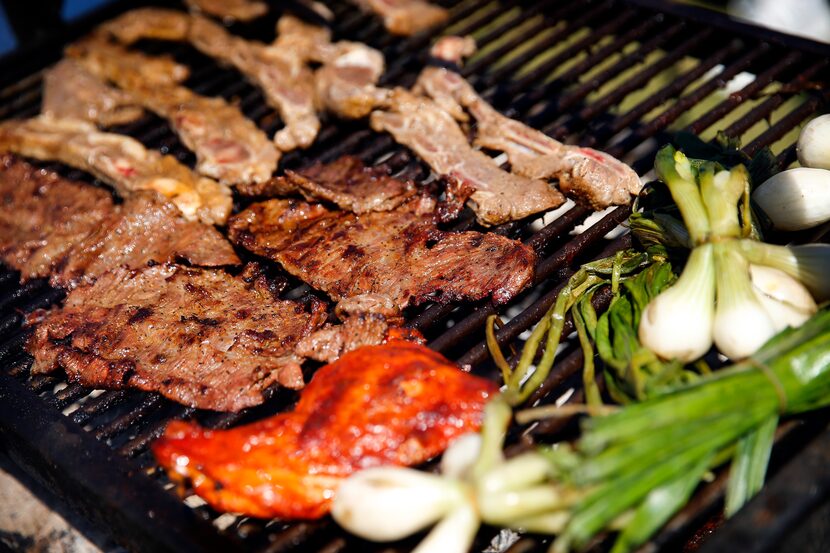 Dallas Cowboys fans grilled fajitas and tablitas at a tailgate party outside AT&T Stadium...