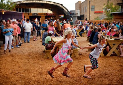 Nine year olds Avery Whipkey (left) and Maddox Snowden play in front of the main stage...