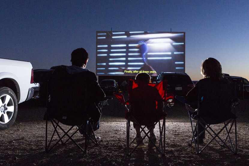 People watch a movie in this file photo of Stars & Stripes Drive-In Theater in New...