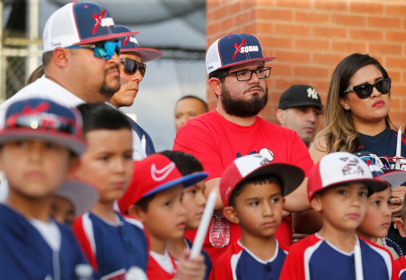 Danny Latin, Ray Garcia, and Jimmy Villatoro of El Paso listen during the candlelight vigil...