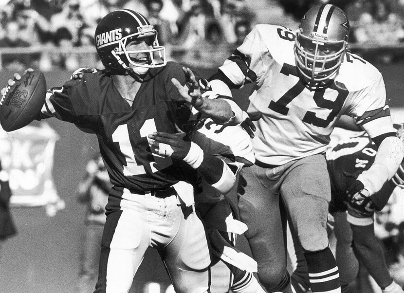 1979 -- Harvey Martin, shown zeroing in on Giants quarterback Phil Simms, played for the...