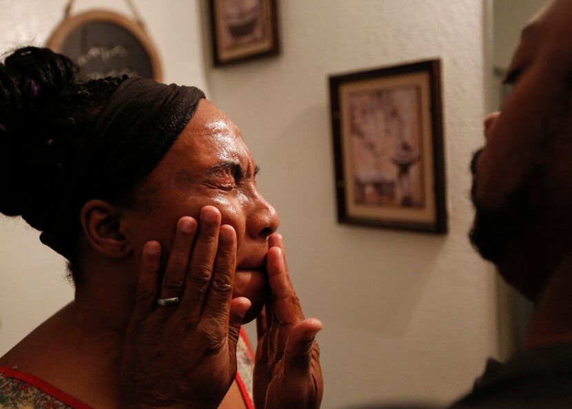 Terrence Barber washes wife Samantha's face as they prepare to leave for a worship service....