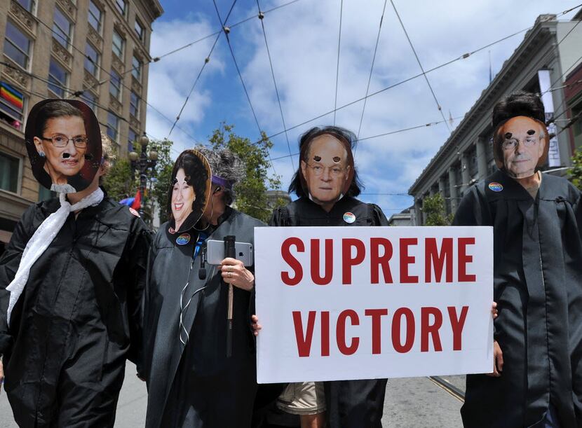 People dressed as United States Supreme Court Justices march along Market Street during the...