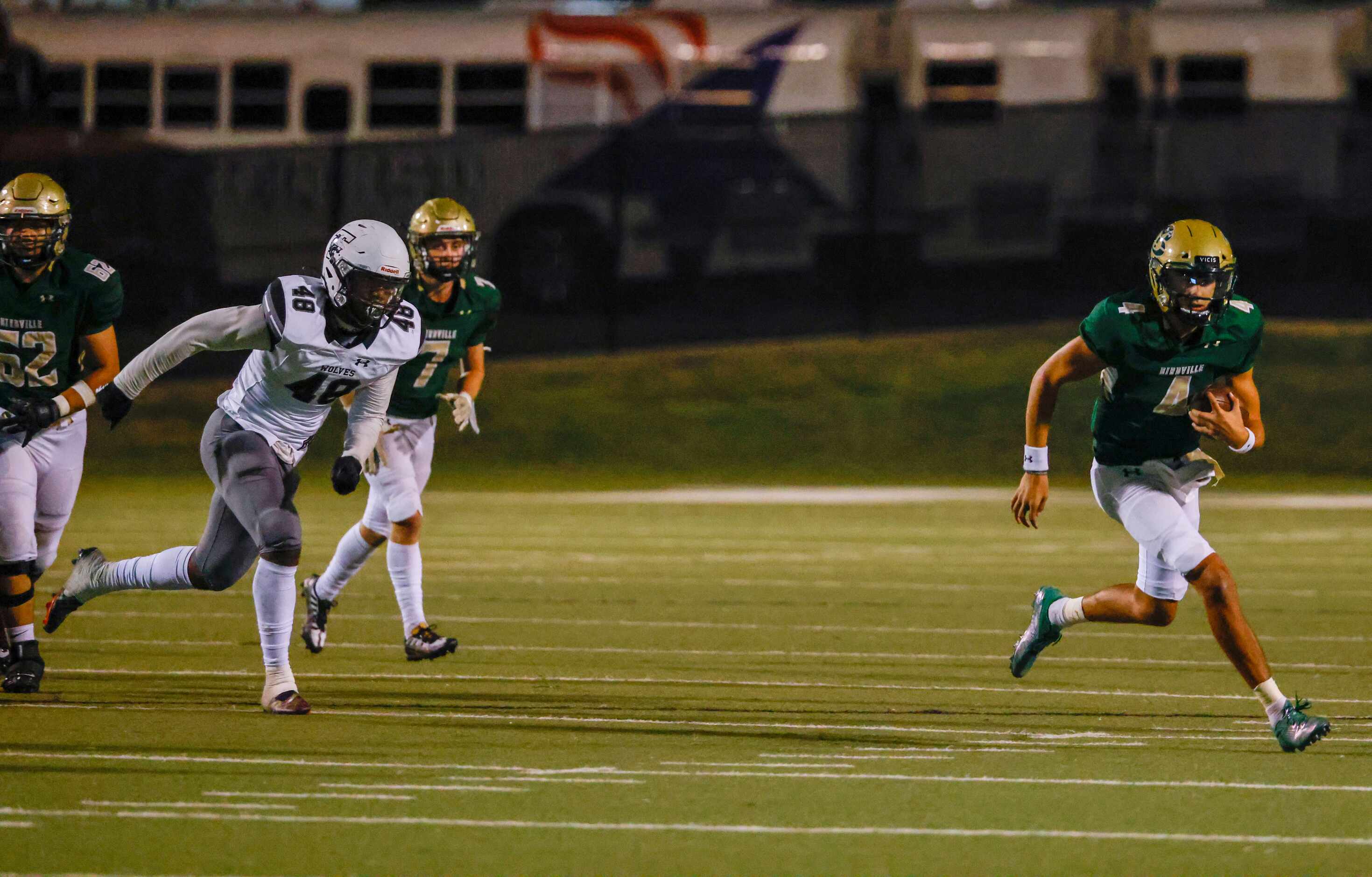 Birdville quarterback Noah Normand (4) carries the ball downfield for a first down during...