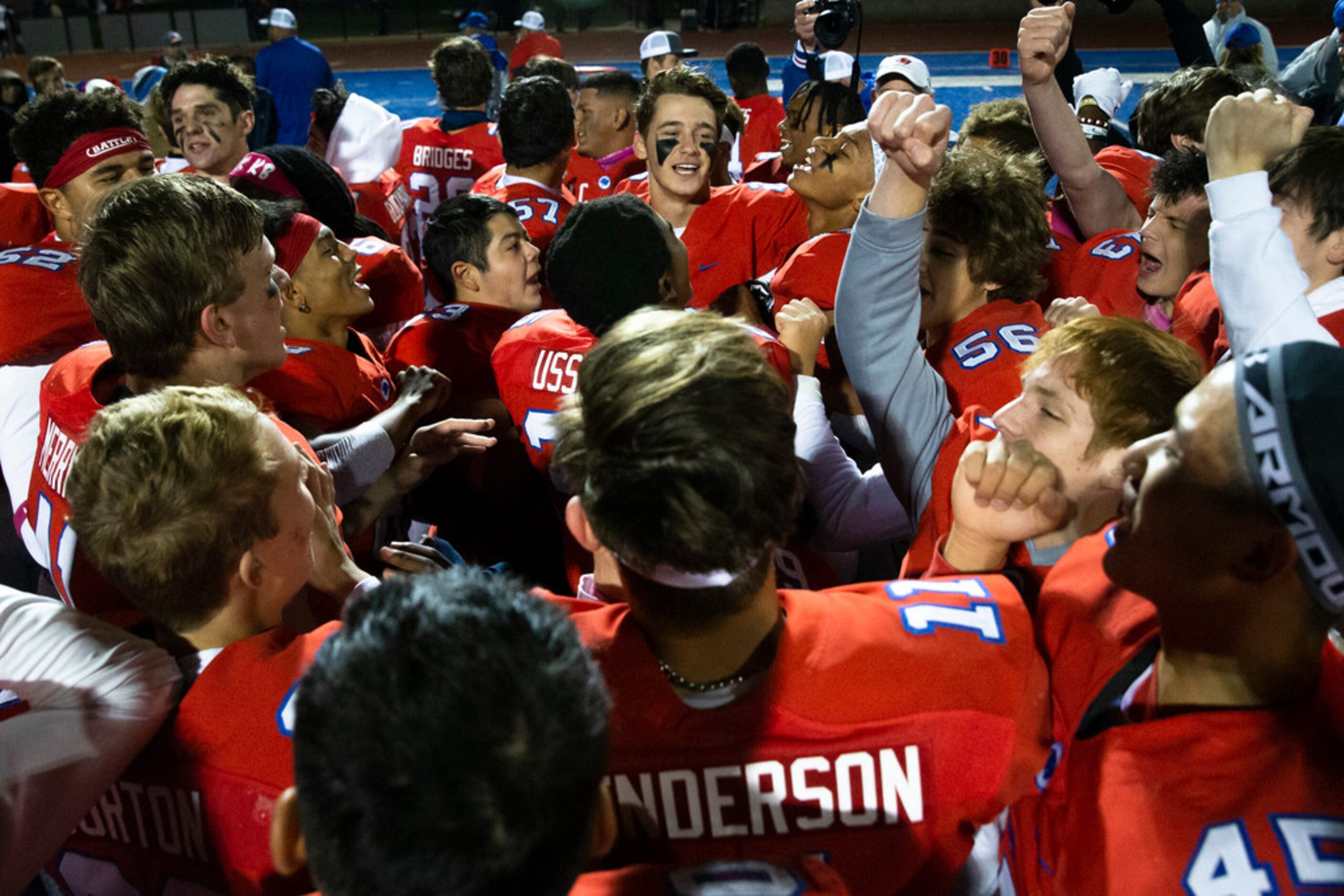 Parish Episcopal quarterback Preston Stone (2, center) leads his team in a celebratory chant...