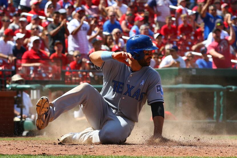 ST. LOUIS, MO - JUNE 19: Mitch Moreland #18 of the Texas Rangers scores the game-winning run...