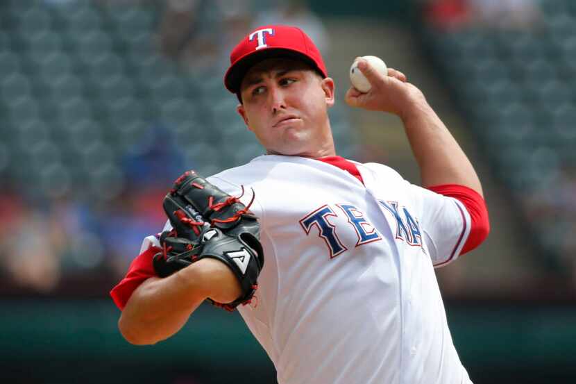 Texas Rangers starting pitcher Derek Holland (45) throws a first inning pitch during the...