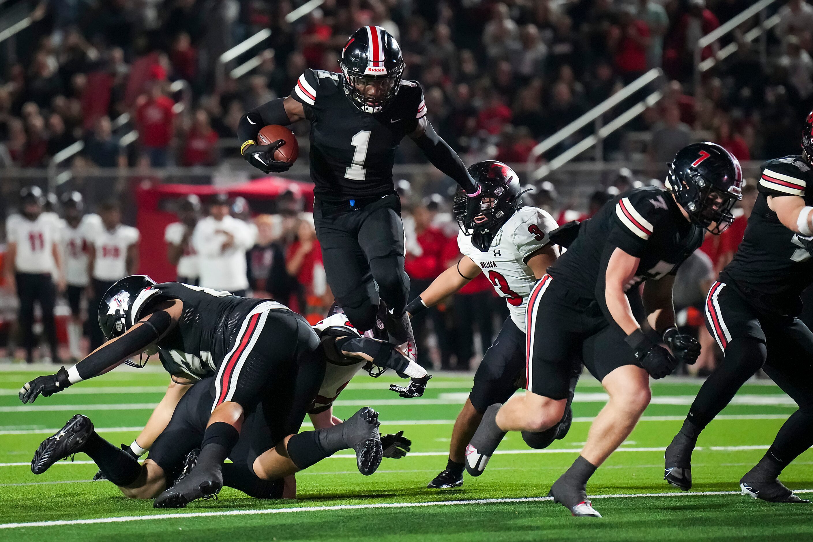 Lovejoy wide receiver Kyle Parker (1) leaps over Melissa linebacker Landen Brandow (25)...