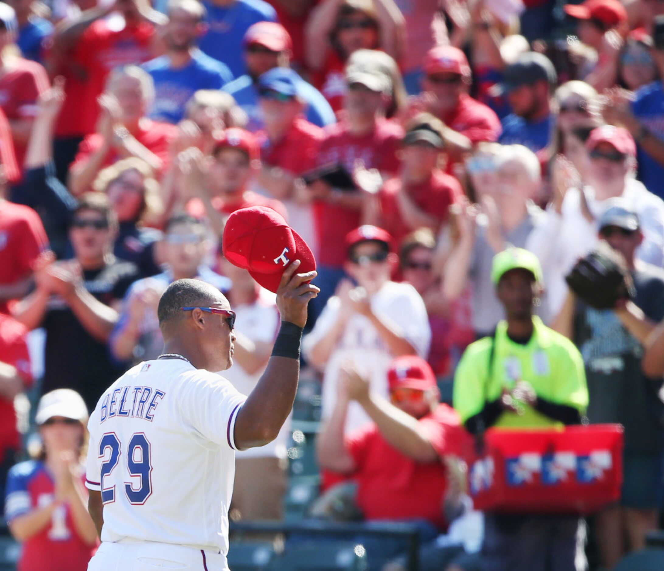 Texas Rangers third baseman Adrian Beltre (29) lifts his hat to the crowd as he leaves the...