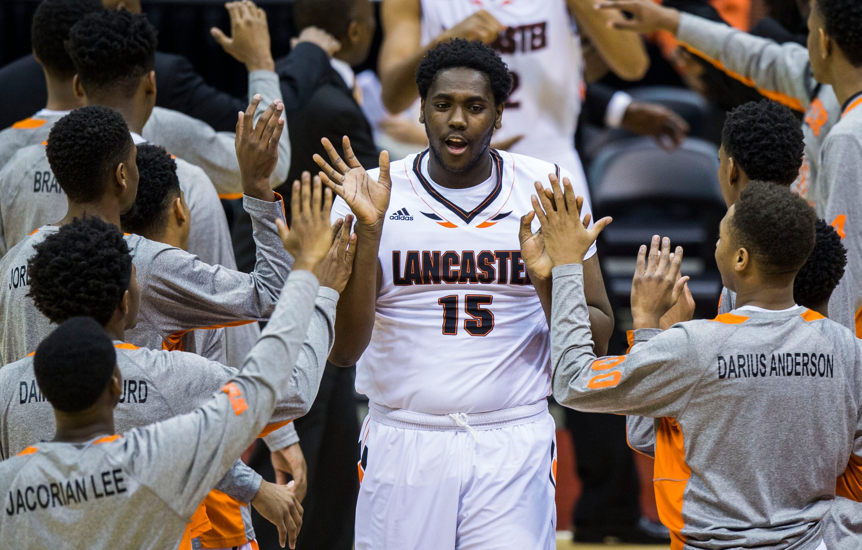 Lancaster forward/center Elijah Thomas (15) high-fives team mates before their UIL Class 5A...