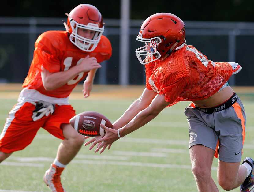 Jake Urbanowski (right) receives a pass while Parker Holman defends while taking part in a...